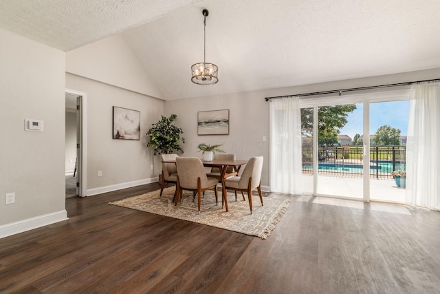 4909 Bixby Rd, Groveport, OH 43125 - dining room featuring a chandelier, dark wood finished floors, a textured ceiling, and vaulted ceiling