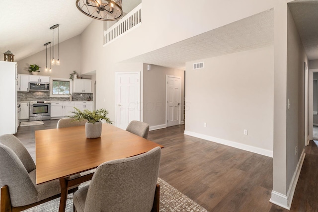 4909 Bixby Rd, Groveport, OH 43125 - dining space with a chandelier, dark wood-type flooring, and high vaulted ceiling