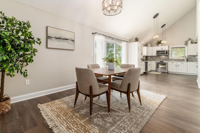 4909 Bixby Rd, Groveport, OH 43125 - dining space featuring a chandelier, healthy amount of natural light, dark wood-style floors, and high vaulted ceiling