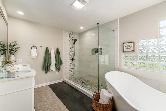 4909 Bixby Rd, Groveport, OH 43125 - bathroom with a freestanding bath, a shower stall, recessed lighting, and double vanity