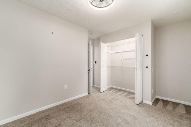 4909 Bixby Rd, Groveport, OH 43125 - unfurnished bedroom featuring light colored carpet, a closet, and a textured ceiling