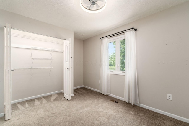 4909 Bixby Rd, Groveport, OH 43125 - unfurnished bedroom featuring light carpet, a closet, and a textured ceiling