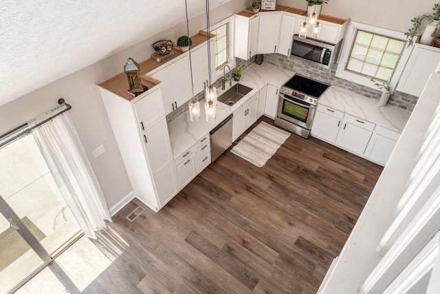 4909 Bixby Rd, Groveport, OH 43125 - kitchen with appliances with stainless steel finishes, tasteful backsplash, dark wood finished floors, white cabinetry, and a textured ceiling