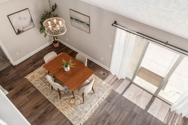 4909 Bixby Rd, Groveport, OH 43125 - dining space featuring wood finished floors, a chandelier, and a textured ceiling