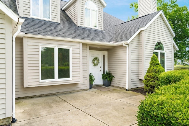 4909 Bixby Rd, Groveport, OH 43125 - entrance to property featuring a shingled roof, a patio, and a chimney