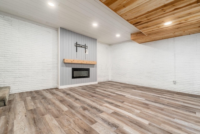 4909 Bixby Rd, Groveport, OH 43125 - unfurnished living room with brick wall, a large fireplace, wood finished floors, recessed lighting, and wooden ceiling