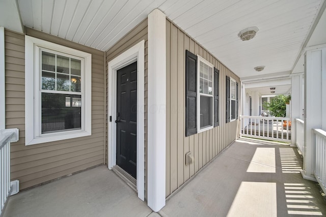 6067 Hayden Farms Rd, Dublin, OH 43016 - view of exterior entry with a porch and board and batten siding
