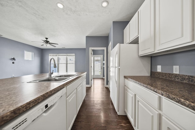 6067 Hayden Farms Rd, Dublin, OH 43016 - kitchen featuring white appliances, dark countertops, a textured ceiling, white cabinets, and dark wood-style flooring