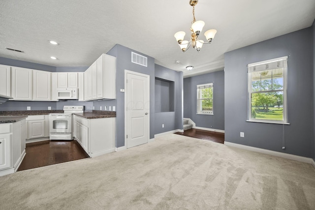 6067 Hayden Farms Rd, Dublin, OH 43016 - kitchen featuring white appliances, dark colored carpet, a chandelier, white cabinetry, and recessed lighting