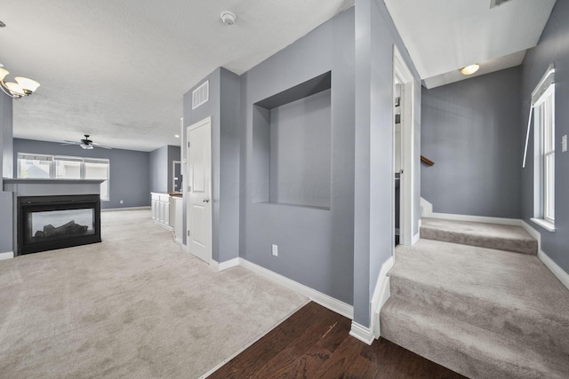 6067 Hayden Farms Rd, Dublin, OH 43016 - hall featuring wood finished floors, stairway, carpet floors, and a textured ceiling