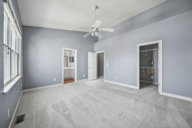 6067 Hayden Farms Rd, Dublin, OH 43016 - unfurnished bedroom featuring carpet, a spacious closet, high vaulted ceiling, ensuite bath, and a ceiling fan