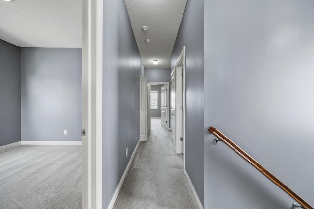 6067 Hayden Farms Rd, Dublin, OH 43016 - corridor with an upstairs landing, light carpet, and a textured ceiling