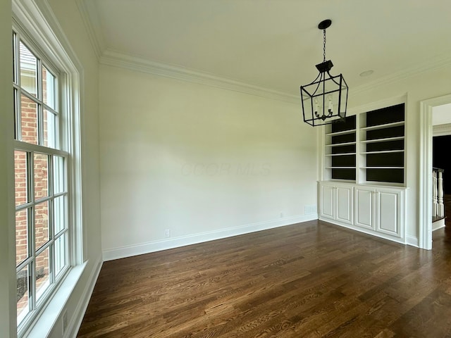 4945 Yantis Dr, New Albany, OH 43054 - unfurnished dining area with a chandelier, ornamental molding, dark wood-type flooring, and built in features