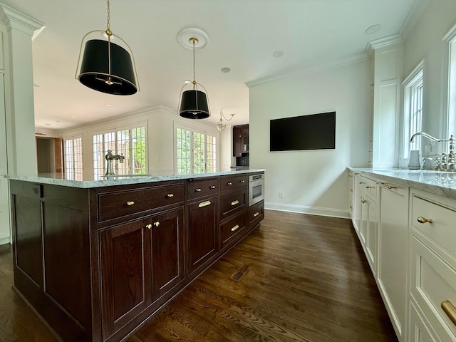 4945 Yantis Dr, New Albany, OH 43054 - kitchen with ornamental molding, dark wood-style flooring, hanging light fixtures, light stone countertops, and dark brown cabinetry