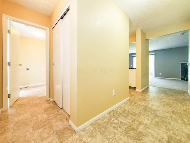 6140 Georges Park Dr Unit 8C, Canal Winchester, OH 43110 - corridor featuring a textured ceiling and baseboards