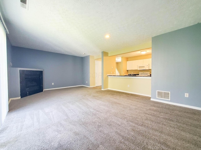 6140 Georges Park Dr Unit 8C, Canal Winchester, OH 43110 - unfurnished living room with a textured ceiling, carpet flooring, and a fireplace