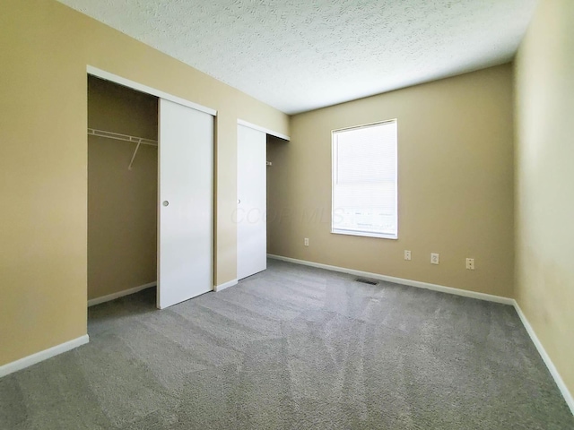 6140 Georges Park Dr Unit 8C, Canal Winchester, OH 43110 - unfurnished bedroom with carpet, a textured ceiling, and two closets