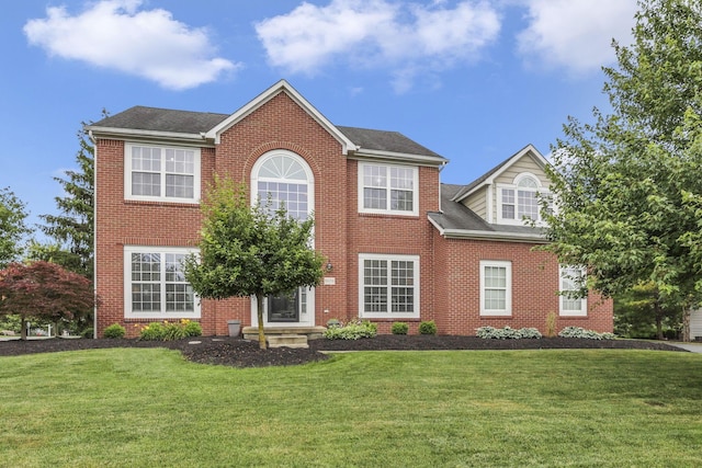 9606 Ireland Ct, Powell, OH 43065 - colonial-style house featuring a front lawn, brick siding, and a shingled roof