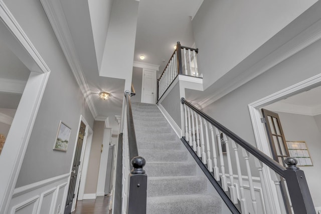 9606 Ireland Ct, Powell, OH 43065 - staircase featuring ornamental molding and a towering ceiling