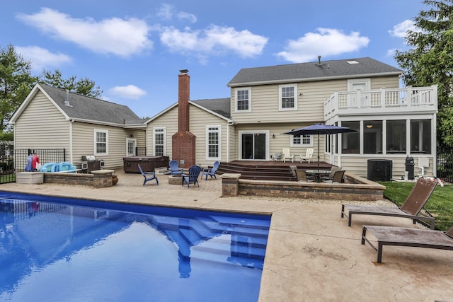 9606 Ireland Ct, Powell, OH 43065 - back of property featuring a hot tub, a patio area, a sunroom, a balcony, and a chimney