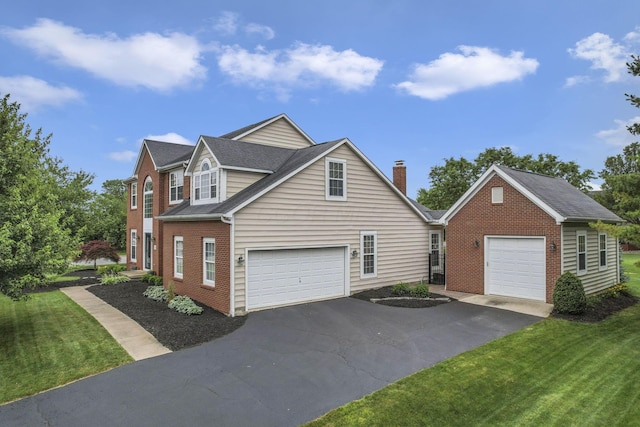 9606 Ireland Ct, Powell, OH 43065 - view of front of home featuring a garage, brick siding, and a front yard