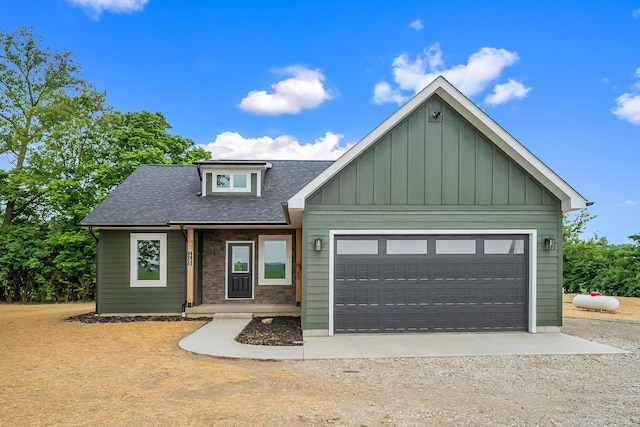 1705 Horseshoe Rd, Delaware, OH 43015 - view of front of property with roof with shingles, an attached garage, board and batten siding, and driveway