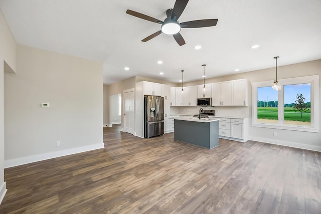 1705 Horseshoe Rd, Delaware, OH 43015 - kitchen featuring stainless steel appliances, light countertops, dark wood-style floors, white cabinetry, and ceiling fan