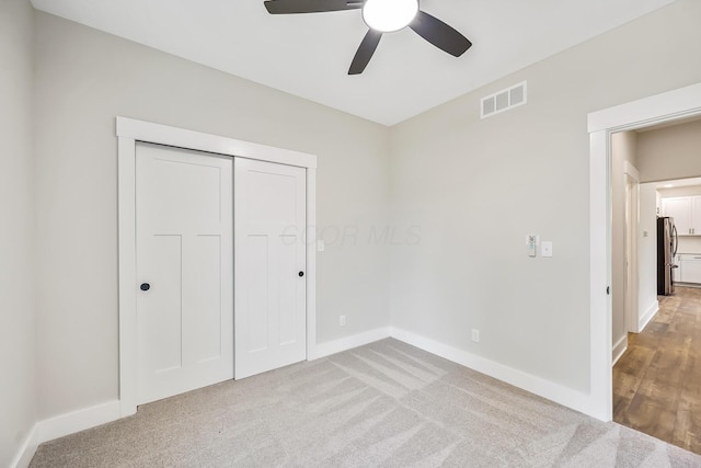 1705 Horseshoe Rd, Delaware, OH 43015 - unfurnished bedroom with freestanding refrigerator, carpet flooring, a closet, and ceiling fan