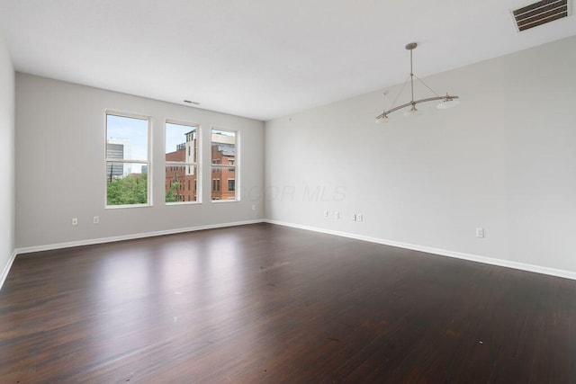 121 E Noble St Unit 3, Columbus, OH 43215 - unfurnished room with dark wood-type flooring and a chandelier