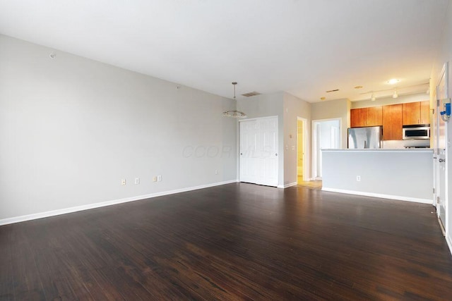 121 E Noble St Unit 3, Columbus, OH 43215 - unfurnished living room with dark wood-style floors and baseboards