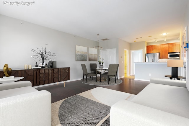 121 E Noble St Unit 3, Columbus, OH 43215 - living area featuring dark wood-style flooring and baseboards