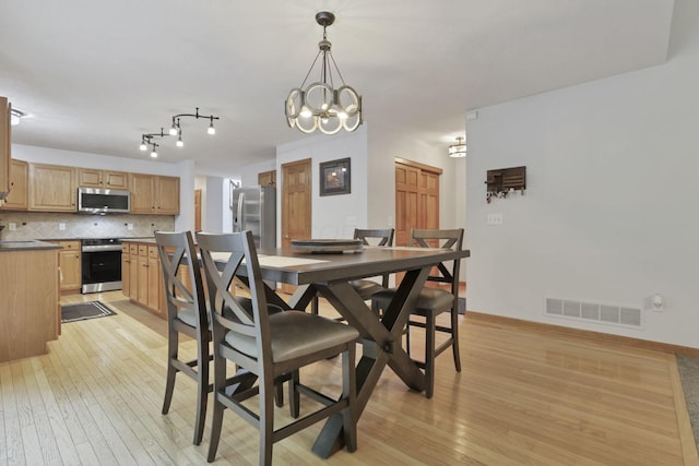 2680 Biers Run Rd, Chillicothe, OH 45601 - dining area featuring light wood finished floors and a chandelier