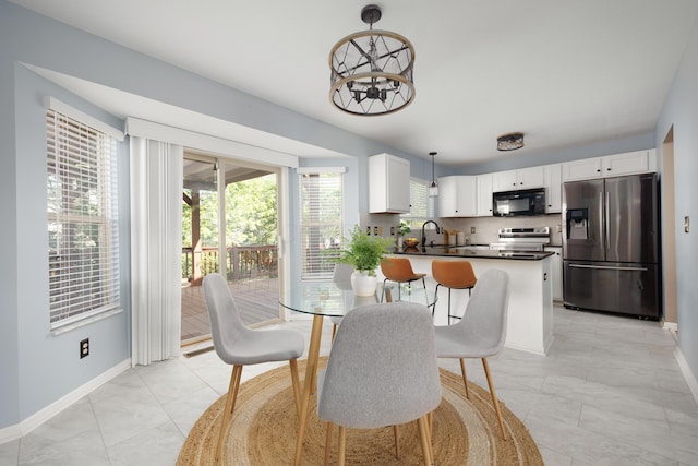 337 Masonglen Ct, Pataskala, OH 43062 - dining space with a chandelier and light marble finish floors
