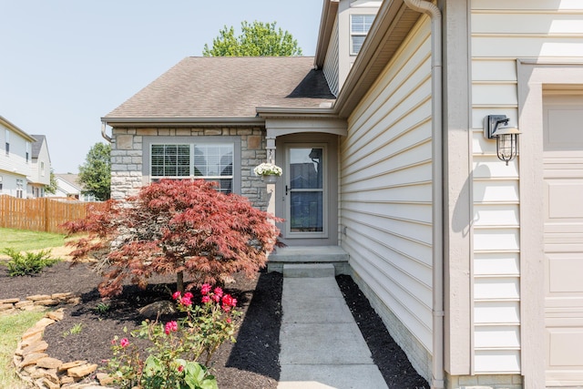 337 Masonglen Ct, Pataskala, OH 43062 - view of exterior entry with a shingled roof and stone siding