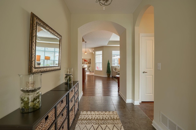 5428 Tathwell Dr, New Albany, OH 43054 - corridor featuring arched walkways and dark tile patterned floors