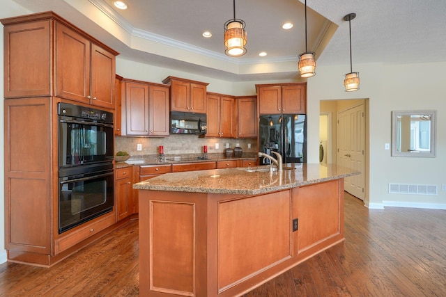 5428 Tathwell Dr, New Albany, OH 43054 - kitchen with black appliances, crown molding, a raised ceiling, brown cabinetry, and tasteful backsplash