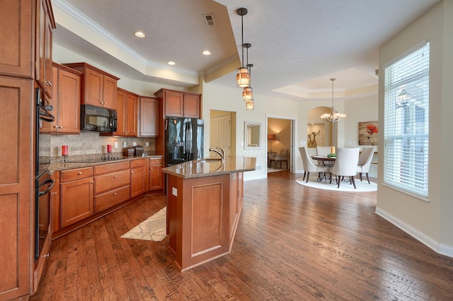 5428 Tathwell Dr, New Albany, OH 43054 - kitchen featuring a raised ceiling, black appliances, brown cabinets, crown molding, and dark wood-style flooring
