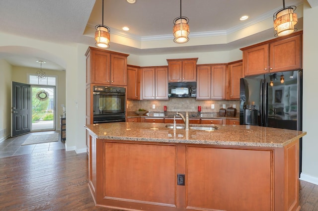 5428 Tathwell Dr, New Albany, OH 43054 - kitchen featuring black appliances, arched walkways, a raised ceiling, dark wood-style floors, and ornamental molding