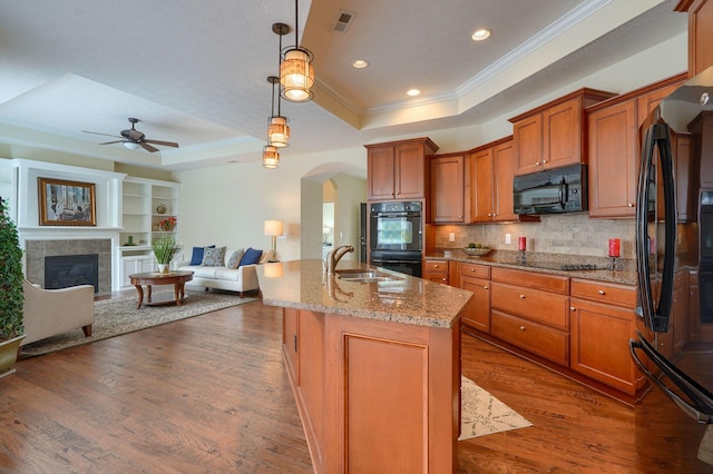 5428 Tathwell Dr, New Albany, OH 43054 - kitchen featuring black appliances, a tray ceiling, crown molding, a ceiling fan, and brown cabinetry