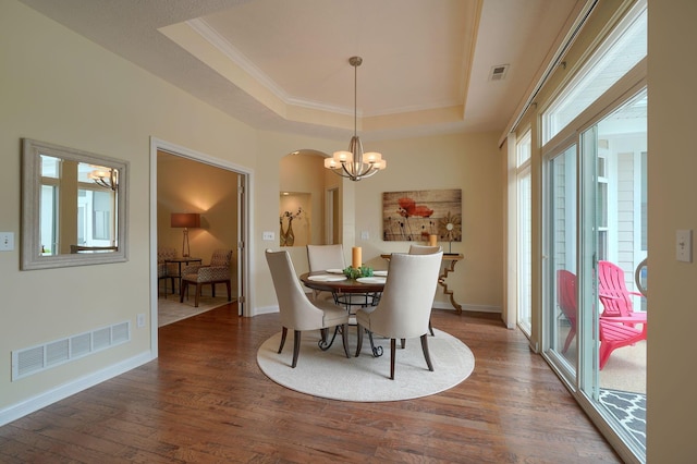 5428 Tathwell Dr, New Albany, OH 43054 - dining area featuring a tray ceiling, a chandelier, wood finished floors, and ornamental molding