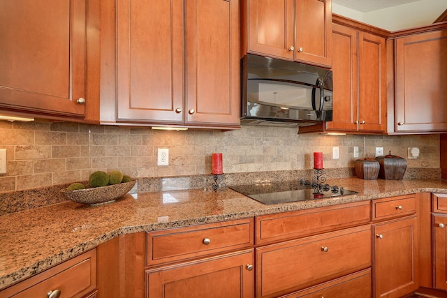 5428 Tathwell Dr, New Albany, OH 43054 - kitchen featuring black appliances, brown cabinets, light stone counters, and decorative backsplash