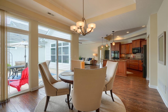 5428 Tathwell Dr, New Albany, OH 43054 - dining room with a raised ceiling, a chandelier, ornamental molding, dark wood-style flooring, and recessed lighting