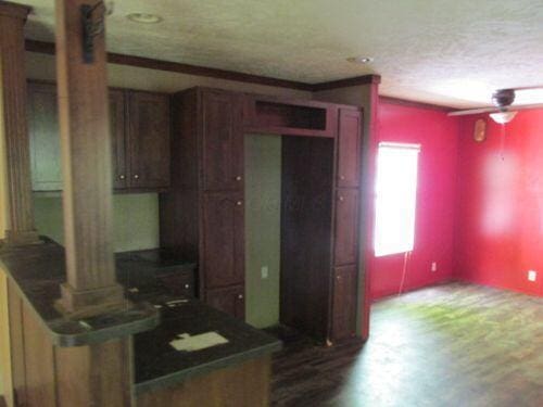 7326 State Route 19 Unit U5 L133, Mount Gilead, OH 43338 - kitchen with ornate columns, a textured ceiling, dark countertops, and dark wood-type flooring