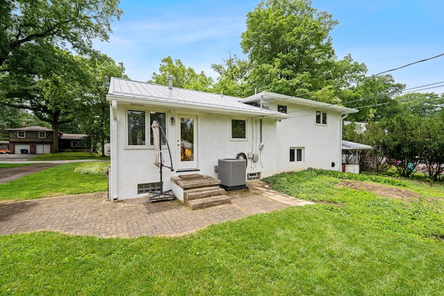 582 E Stanton Ave, Columbus, OH 43214 - back of house with a lawn, a metal roof, and stucco siding