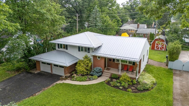 582 E Stanton Ave, Columbus, OH 43214 - view of front of house with brick siding, a porch, a metal roof, a standing seam roof, and a gate