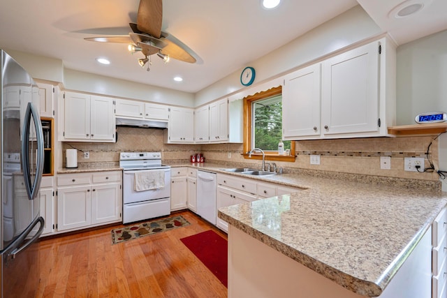 582 E Stanton Ave, Columbus, OH 43214 - kitchen with white appliances, under cabinet range hood, light wood-type flooring, a ceiling fan, and a peninsula