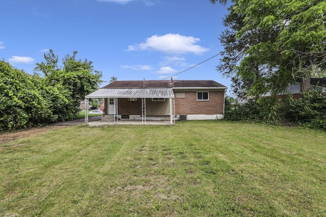2103 Rochelle Pl, Columbus, OH 43232 - rear view of house featuring brick siding, a patio, and a yard