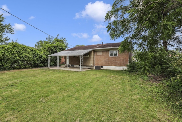 2103 Rochelle Pl, Columbus, OH 43232 - back of property with a patio, brick siding, and a lawn