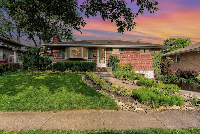 4453 Marland Dr, Columbus, OH 43224 - ranch-style home with a chimney, brick siding, and a yard