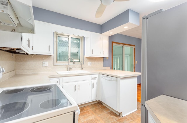 4453 Marland Dr, Columbus, OH 43224 - kitchen featuring white appliances, under cabinet range hood, light countertops, white cabinetry, and recessed lighting